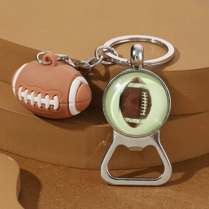 Close-up of brown rugby ball keychain and integrated metal bottle opener on a stand