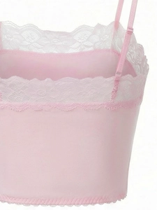 Detail of pink lace bra with adjustable straps and delicate white floral lace embroidery