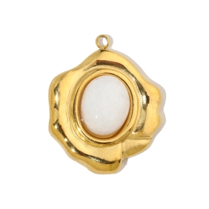 Detail of a golden waterdrop pendant with a white oval gemstone and organic metal frame