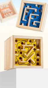 Close-up of wooden balance maze with numbered tracks and metal ball for concentration