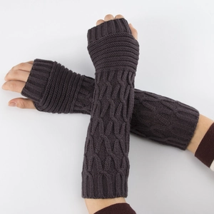 Detailed knit texture of long dark purple cable-knit fingerless arm warmers on model