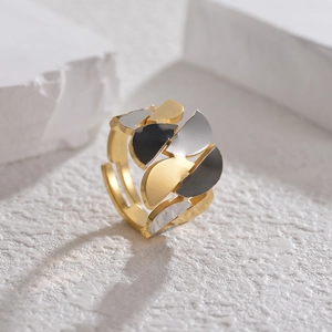 Macro shot of adjustable irregular geometric ring with gold, silver and black finishes