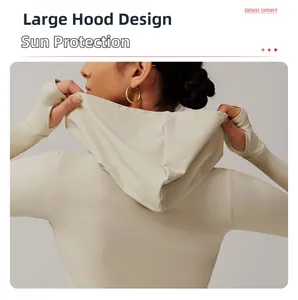 Close-up of cream yoga jacket featuring an integrated large hood and thumbhole sleeves