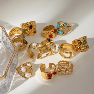 Retro 18k gold plated stainless steel rings with pearls and gemstones on white background