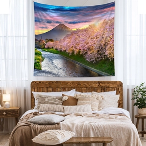 Detail of Mount Fuji tapestry featuring cherry blossoms and sunset over a bedroom bed