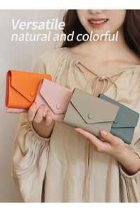 Litchi pattern leather slim wallets in orange, pink, grey, and green shown by model
