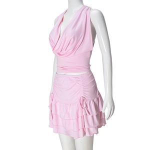 Side view of pink halter neck top and layered ruffle mini skirt on a mannequin