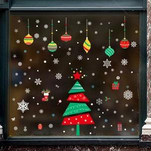 Detail of festive Christmas tree and snowflake static window clings on glass pane
