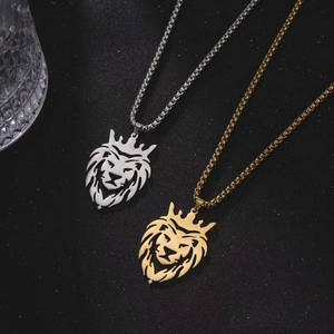 Golden and silver lion head pendant necklaces with rope and snake chains on dark texture
