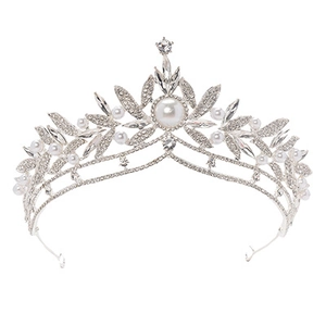Detailed view of bridal crown featuring leaf patterns with sparkling rhinestones and pearls