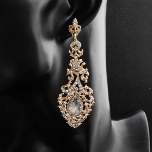 Macro shot of vintage baroque drop earrings with rhinestones and pear-cut crystal charms