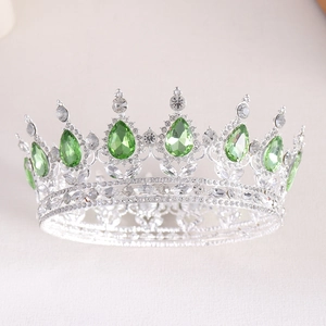 Detailed view of silver bridal crown with green teardrop gems and sparkling rhinestones