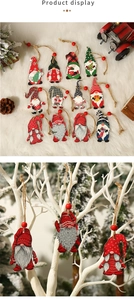 Close-up of painted wooden Christmas gnomes with rustic twine and red bead hangers