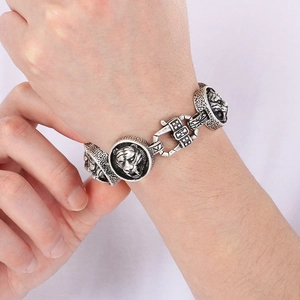 Detailed view of men's tiger head bracelet in silver finish on male wrist
