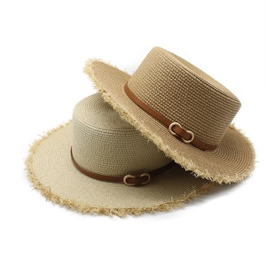 Détail de chapeaux canotiers en raphia avec ceintures en cuir et bords effilochés