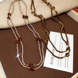 Detailed shot of ethnic tiger eye beaded necklaces in brown and reddish tones