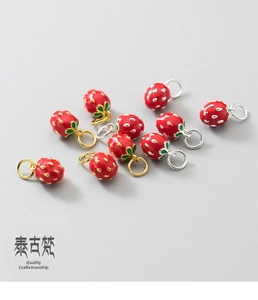 Detailed view of red enamel strawberry charms for DIY jewelry making in gold and silver