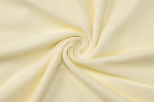 Macro detail of breathable beige knitted mesh fabric showing texture and soft drape