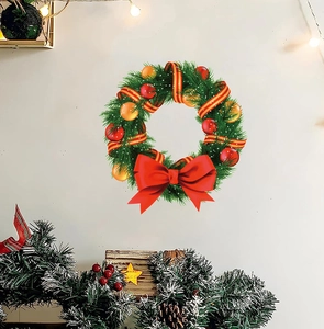 Detailed view of a Christmas wreath wall sticker with a large red bow on a warm white wall