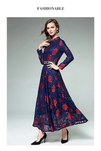 Detailed texture of navy blue lace dress with red rose floral patterns and slim belt