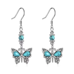 Bohemian silver earrings with turquoise butterfly pendants shown on white background