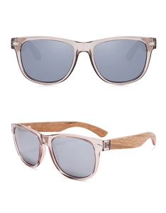 Detail view of oval sunglasses featuring natural wood temples and grey polarized lenses