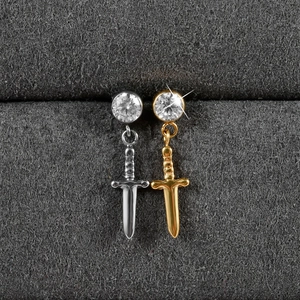 Macro view of G23 titanium sword pendants with zircon inlays in gold and silver finishes