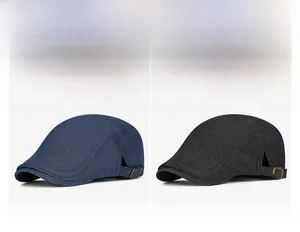 Detail of denim beret hats showing adjustable metal buckles and high-quality fabric texture
