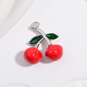 Creative cherry pendant with red fruit charms and green leaves on a white background