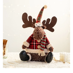 Detail of Christmas reindeer plush in red tartan jacket with cozy knitted scarf