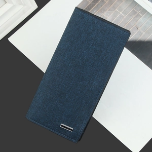 Close-up of deep blue fabric texture and metal hardware on a slim long wallet for men