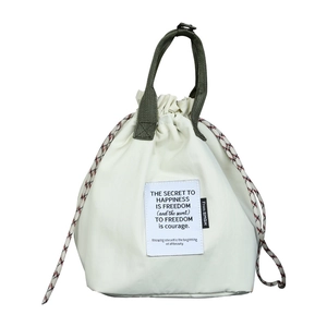 Insulated drawstring lunch bag in cream white with olive green handles and bucket shape