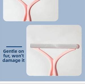 Close-up of the Y-shaped handle and textured head of the pink lint remover tool