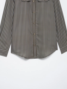 Detail of olive green striped poplin shirt with brown buttons and curved hemline