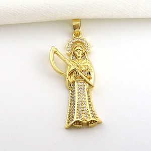 Macro shot of gold Santa Muerte pendant with micro-pave white cubic zirconia details