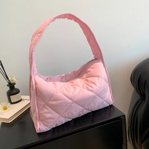 Detailed shot of pink quilted nylon shoulder bag showing fine stitching and zip closure