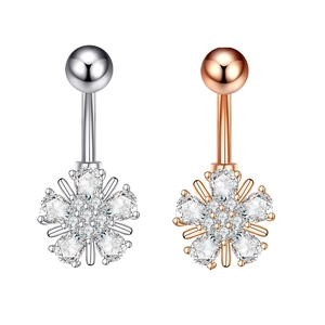 Detailed view of flower-shaped belly rings in silver and rose gold with zircon stones