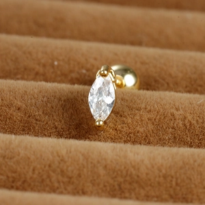 Detail of marquise-cut zircon stud earring with a golden screw ball back closure