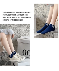 Detailed view of navy blue low-cut cotton sock with white embroidered letter P