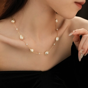 Detail of baroque pearl necklace with irregular pearls on a gold-plated chain