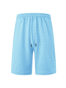 Detailed view of light blue shorts featuring herringbone textured fabric and drawstring