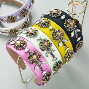 Detail of luxury baroque headbands featuring colorful glass rhinestones and jewels