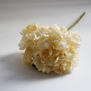 Macro detail of artificial coral hydrangea with vintage scorched edges in cream yellow