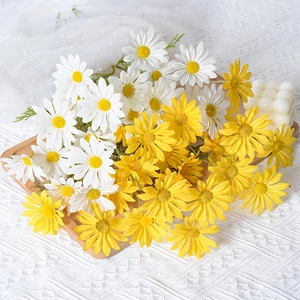 Artificial white and yellow daisies bouquet for home wedding decoration with lace background