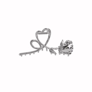 Vintage silver metal rose and heart hair claw clip with a glossy finish on white background