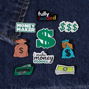 Detailed view of money themed enamel pins and dollar signs on dark blue denim fabric