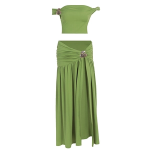 Close-up of metallic flower hardware on green ruched two-piece vacation set
