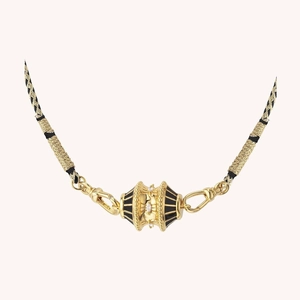 Macro shot of 18K gold plated necklace featuring black enamel pendant with white diamonds