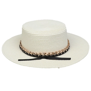 Detailed texture of straw weave featuring a gold metal chain and black ribbon detail