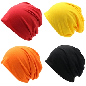 Close-up collage of knitted beanie hats in red, yellow, orange and black colors
